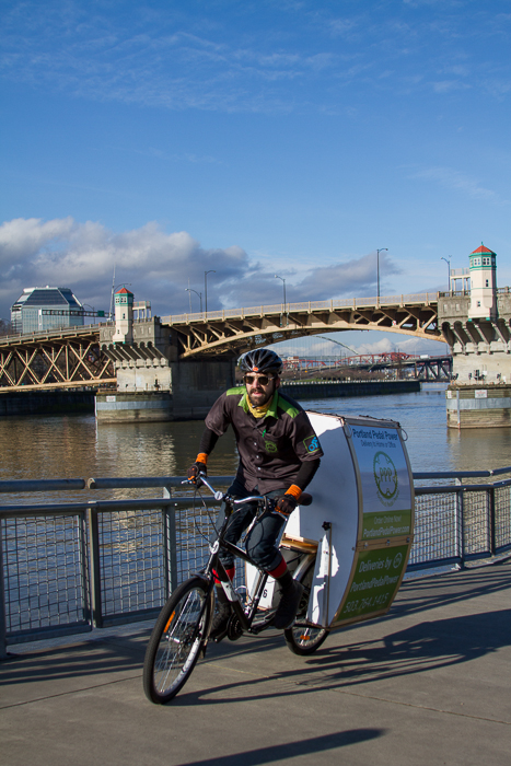 Portland Pedal Power deliveryman shredding on the water front with bike